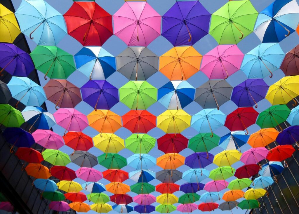 color-umbrella-red-yellow-163822-163822 Yellow Blue Red Pink Purple Green Multicolored Open Umbrellas Hanging on Strings Under Blue Sky